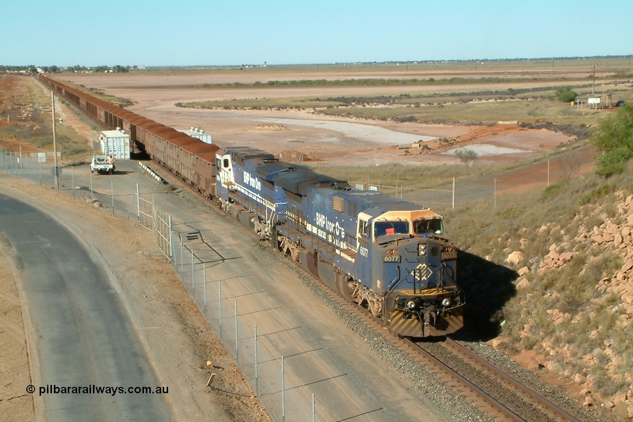 040802 090026r
Redbank, Nelson Point yard entrance BHP GE AC6000 6077 'Nimingarra' serial 51069 and Goninan CM40-8M rebuild 5654 'Kashima' serial 8412-11/93-145 arrive in Nelson Point with a loaded Yandi, of note was the mid-train engines EMD SD40R units 3090-3089 and CM40-8M 5636 had engineers on-board to carry out tests on the SD40R locomotives 2nd August 2004.
Keywords: 6077;GE;AC6000;51069;