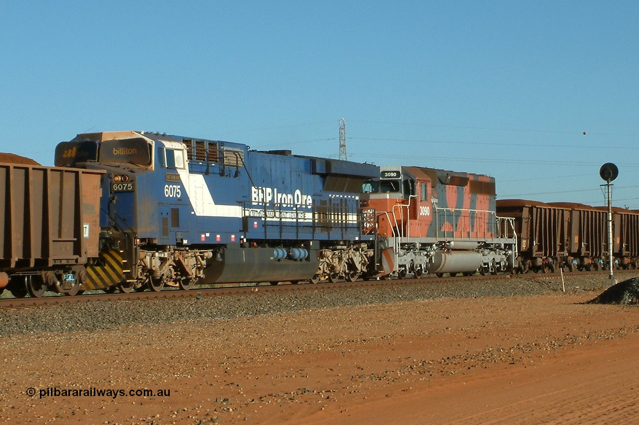 040811 161750r
Goldsworthy Junction, BHP GE AC6000 6075 'Newman' serial 51067 is in mid-train controlling remote service on a loaded train with the windscreen protecting blinds up and leading EMD SD40R unit 3090 serial 33680 originally Southern Pacific SD40 SP 8488 11th August 2004.
Keywords: 6075;GE;AC6000;51067;