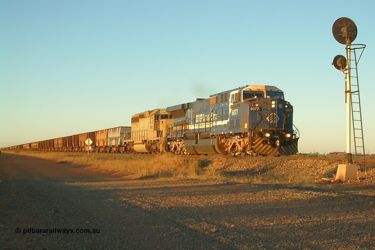 040811 173538r
Goldsworthy Junction BHP GE AC6000 6077 'Nimingarra' serial 51069 and EMD SD40-2 3085 serial 786170-25 formally Union Pacific UP 3523 are in charge of an empty train at signal TR13 (transfer road switch, Goldsworthy Junction) mid-train units can just be seen in frame 11th August 2004.
Keywords: 6077;GE;AC6000;51069;