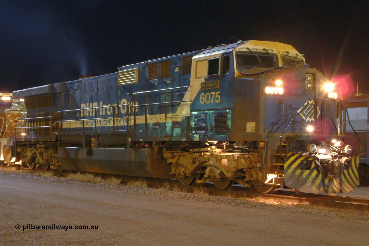 040819 042026r
Nelson Point yard, BHP GE AC6000 6075 'Newman' serial 51067 waits in the early hours of 19th August 2004 with a loaded rake for entry into Car Dumper 3 and the dumping of its train.
Keywords: 6075;GE;AC6000;51067;