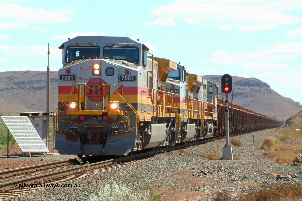 050108 142945r
Cape Lambert, Hamersley Iron owned Pilbara Iron General Electric built Dash 9-44CW unit 7061 serial 54768 leads Robe owned Pilbara Rail 9402 serial 53456 and Hamersley Iron 7085 serial 47764 with a loaded train from the Deepdale mine past signal OB1 on the line to Cape Lambert. The switch for the quarry triangle is just in front of the train. Saturday 8th January 2005.
Keywords: 7061;GE;Dash-9-44CW;54768;