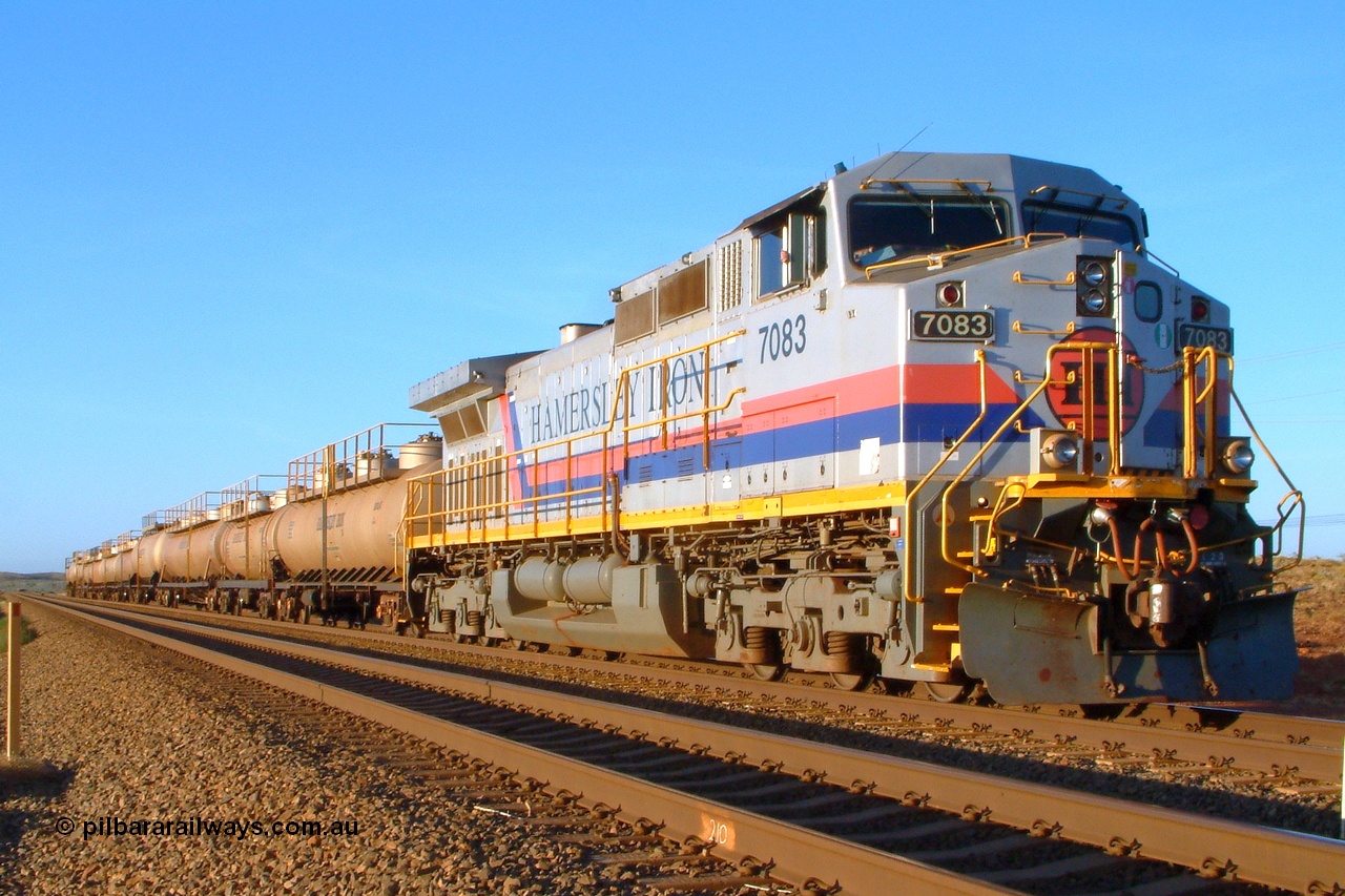 050108 182036r
Dingo Siding, Hamersley Iron's General Electric built Dash 9-44CW unit 7083 serial 47762 heads up the motley collection of eleven tank waggons that form the Hamersley Iron fuel train. Saturday 8th January 2005.
Keywords: 7083;GE;Dash-9-44CW;47762;