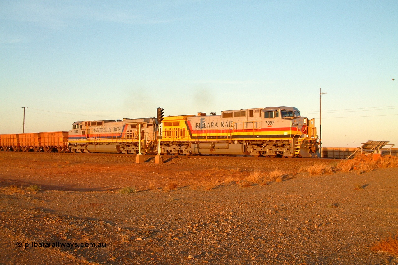 050108 184314r
Seven Mile yard departure with Hamersley Iron owned Pilbara Rail liveried General Electric built Dash 9-44CW unit 7097 'Ken Onley' serial 54160 and sister Hamersley Iron liveried 7093 serial 47772 power out of the yard an empty working in the late afternoon light at 1843 hrs Saturday 8th January 2005.
Keywords: 7097;GE;Dash-9-44CW;54160;