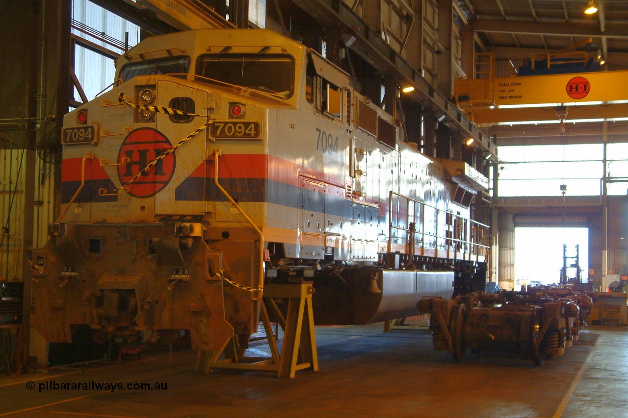 050109 181900r
Seven Mile, Hamersley Iron General Electric built Dash 9-44CW unit 7094 serial 52841 sits in the shed partially stripped for accident repairs. Note the knuckle has been pushed right back into the draft pack as a result of the impact. Sunday 9th January 2005.
Keywords: 7094;GE;Dash-9-44CW;52841;