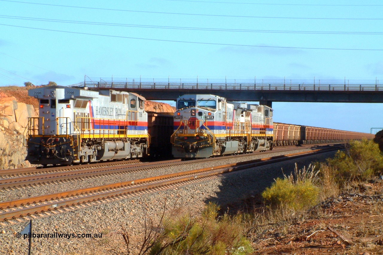 050110 072701r
Parker Point, brilliant summer morning light captures the driver in charge of General Electric built Dash 9-44CW units 7073 serial 47752 and 7078 serial 47757 stops to have a chat with the driver of the Parker Point dumper pilot on 7096 serial 52843 all wearing the original Hamersley Iron 'Pepsi' livery. Monday 10th January 2005.
Keywords: 7096;GE;Dash-9-44CW;52843;