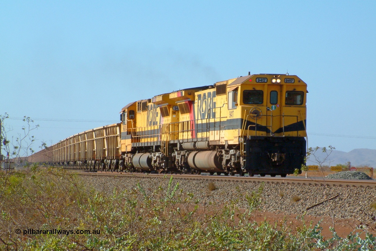 050110 082816r
Seven Mile, just over the salt mine grade crossing, former Robe River Goninan rebuilt CM40-8M locomotives 9417 serial 6266-5/89-83 and 9420 serial 8109-3/91-119 now relegated to non mainline duties as they don't have the ICSS (in-cab signalling) fitted are seen here working a loaded bound for the East Intercourse Island dumper. Monday 10th January 2005. History of these two units 9417 was built by ALCo as C636 serial 6010-1 of November 1968 for Spokane Portland & Seattle as their #340, then to Chesapeake & Ohio as #2100, Burlington Northern #4366, purchased by Robe River and rebuilt into CM40-8M in June 1989. 9420 was built by ALCo as C630 serial 3486-4 of October 1967 for Chesapeake & Ohio as #2103, purchased by Robe River in January 1975, #9420, then rebuilt to CM40-8M in 1991 by Goninan.
Keywords: 9417;Goninan;GE;CM40-8M;6266-5/89-83;rebuild;ALCo;Schenectady-NY;C636;BN4366;6010-1;