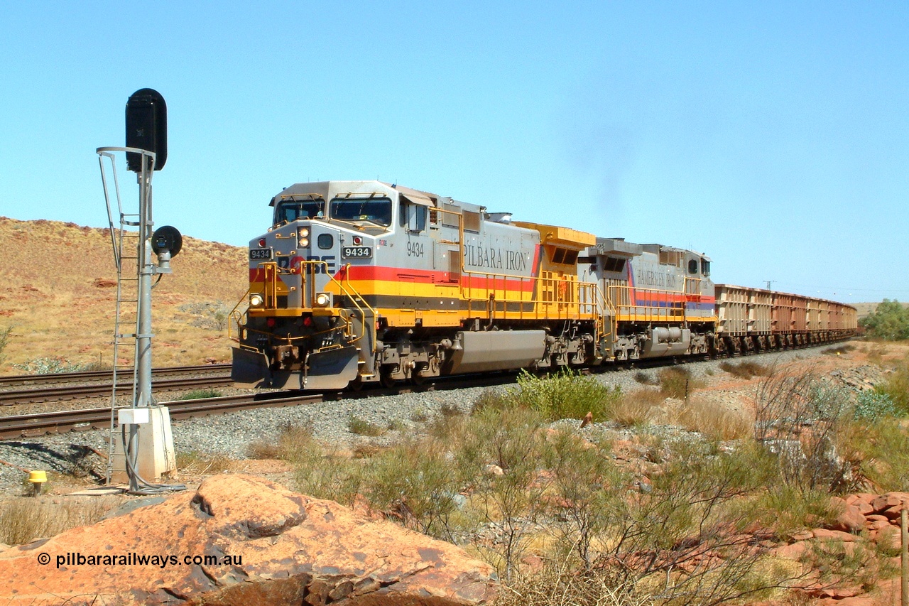 050110 100724r
Western Creek junction, Robe River owned General Electric Dash 9-44CW unit 9434 serial 54767 in Pilbara Iron livery leads similar Hamersley Iron owned unit 7095 serial 52842 in original livery off the interconnecting line from the Cape Lambert - Deepdale line onto the Dampier - Tom Price line with an empty train bound for West Angelas. This junction is known as Western Creek and the double track of Emu can be seen to the left. Monday 10th January 2005.
Keywords: 9434;GE;Dash-9-44CW;54767;