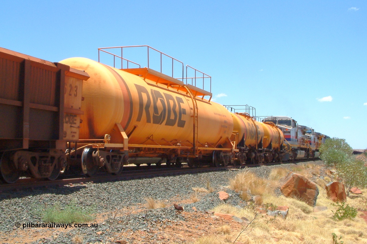 050110 122348r
Maitland Siding, an empty Mesa J bound train runs along the passing track crossing a loaded sitting on the mainline. The tank waggons behind the locos are 8001 and 8002 both built in 1972 with a 45,000 litre capacity and 8003 built in 1979 with a 100,000 litre capacity, all three were built by Comeng NSW. Monday 10th January 2005.
Keywords: 8003;Comeng-NSW;