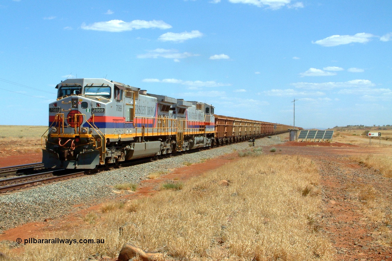 050110 142848r
Gull Siding the 105 km at the top of the Chichester Range, double General Electric built Dash 9-44CW Hamersley Iron units 7069 serial 47748 and 7077 serial 47756 lead 230 loaded waggons as they prepare to descend the Chichester Range bound for Cape Lambert Monday 10th January 2005.
Keywords: 7069;GE;Dash-9-44CW;47748;