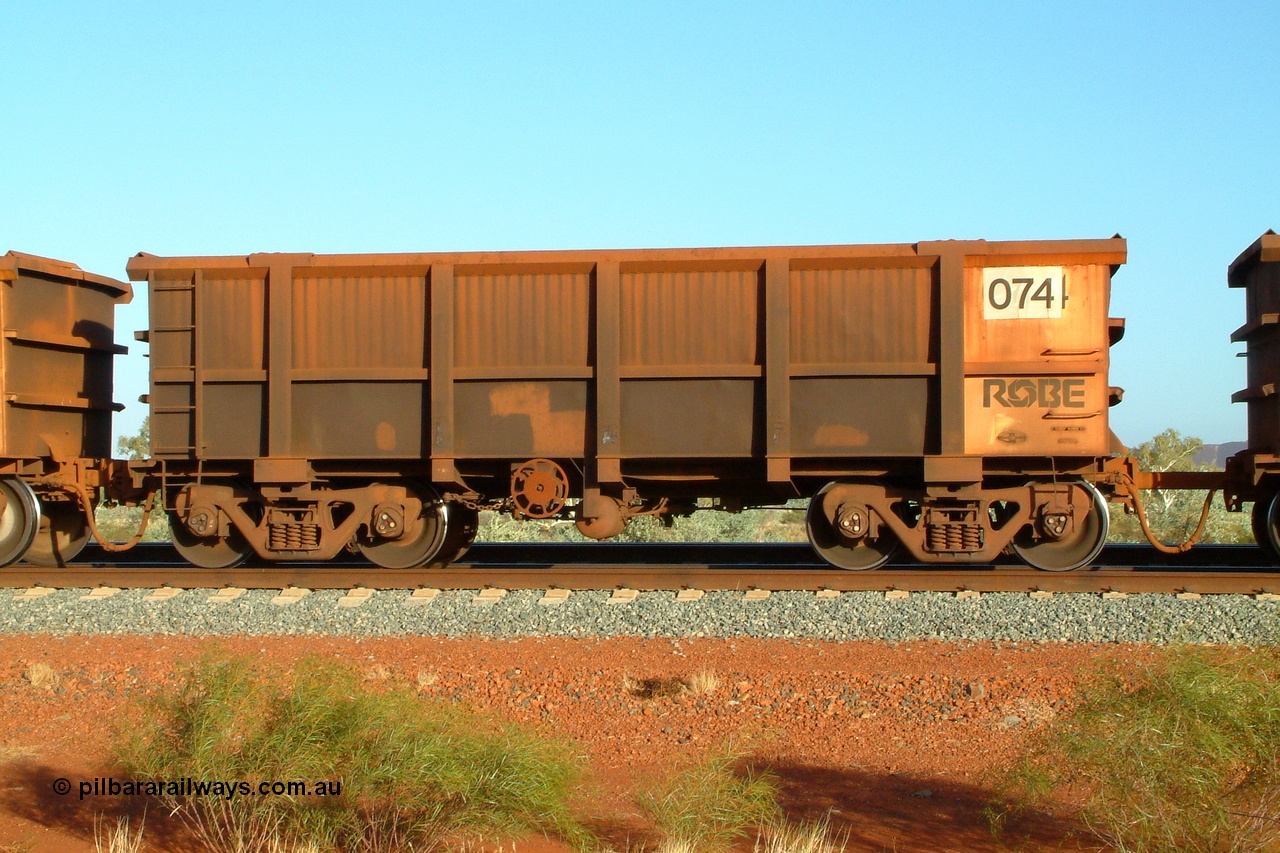 050110 175326r
Harding Siding, Robe River ore waggon 074 built by Nippon Sharyo Nihon in 1971 is one of a few waggons that runs permanently coupled to another waggon. Unlike the Hamersley Iron system married pairs, the Robe fleet each have their own brake system and are coupled by a length of round bar as the Cape Lambert dumper only dumps one waggon at a time. Monday 10th January 2005.
Keywords: Nippon-Sharyo-Japan;