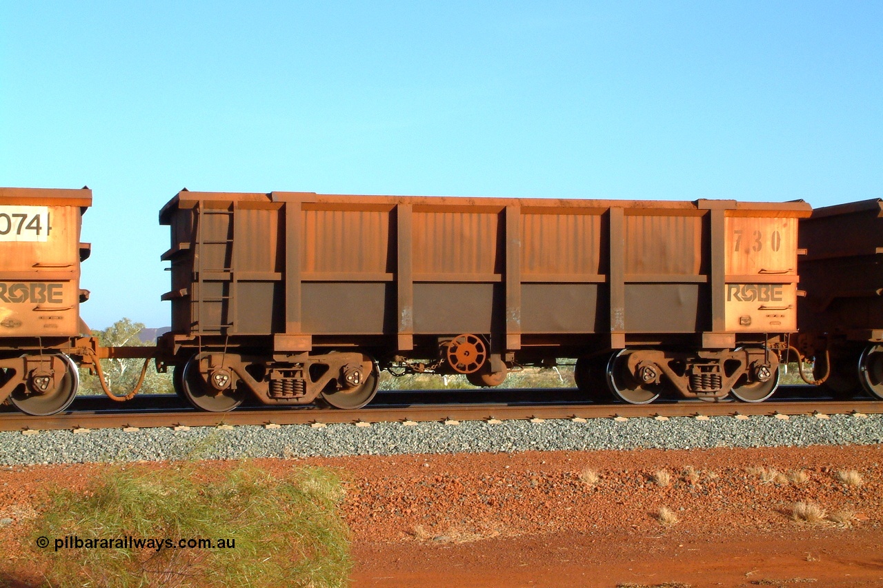 050110 175330r
Harding Siding, Robe River ore waggon 730 built by Tomlinson Steel Perth in 1982 is one of a few waggons that runs permanently coupled to another waggon. Unlike the Hamersley Iron system married pairs, the Robe fleet each have their own brake system and are coupled by a length of round bar as the Cape Lambert dumper only dumps one waggon at a time. Monday 10th January 2005.
Keywords: Tomlinson-Steel-WA;