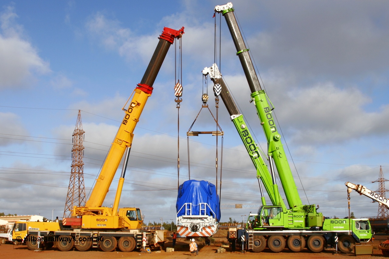 051023 6119r
Nelson Point hard stand, BHP Billiton's brand new Electro-Motive built SD70ACe/LC unit 4301 serial 20038540-002 is lowered onto the rails by three Boom Logistics cranes, a 200, 160 and 120 tonne units. Sunday 23rd October 2005.
Keywords: 4301;Electro-Motive;EMD;SD70ACe/LC;20038540-002;