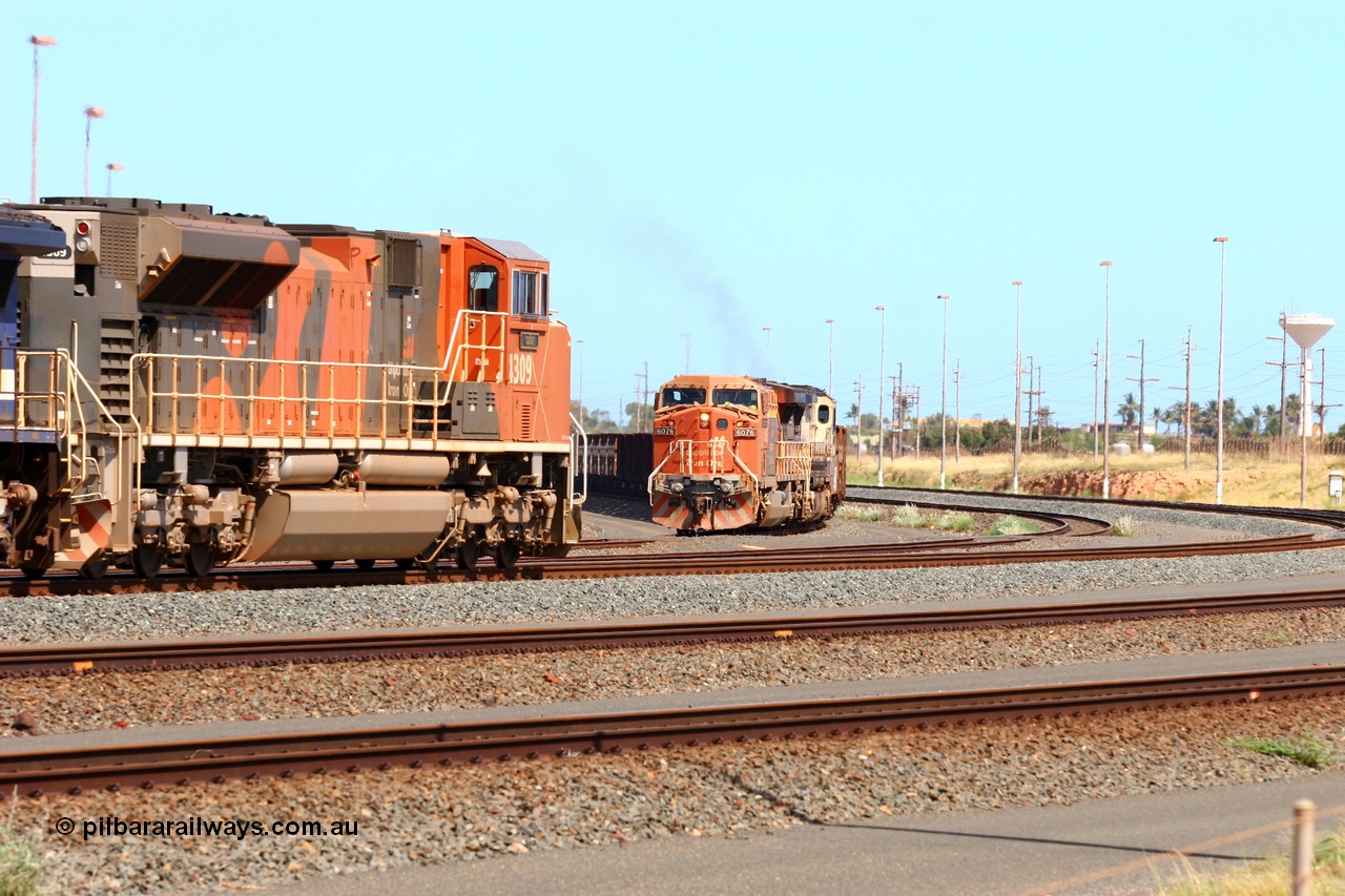 060225 2978r
Nelson Point yard sees BHP Billiton Electro-Motive built SD70ACe unit 4309 'Gidgi' serial 20038540-010 passing General Electric built AC6000 6076 'Mt Goldsworthy' serial 51068. 4309 is leading a loaded train towards the dumpers while 6076 is taking empty cars to the departure yard. 25th February 2006.
Keywords: 4309;Electro-Motive;EMD;SD70ACe/LC;20038540-010;