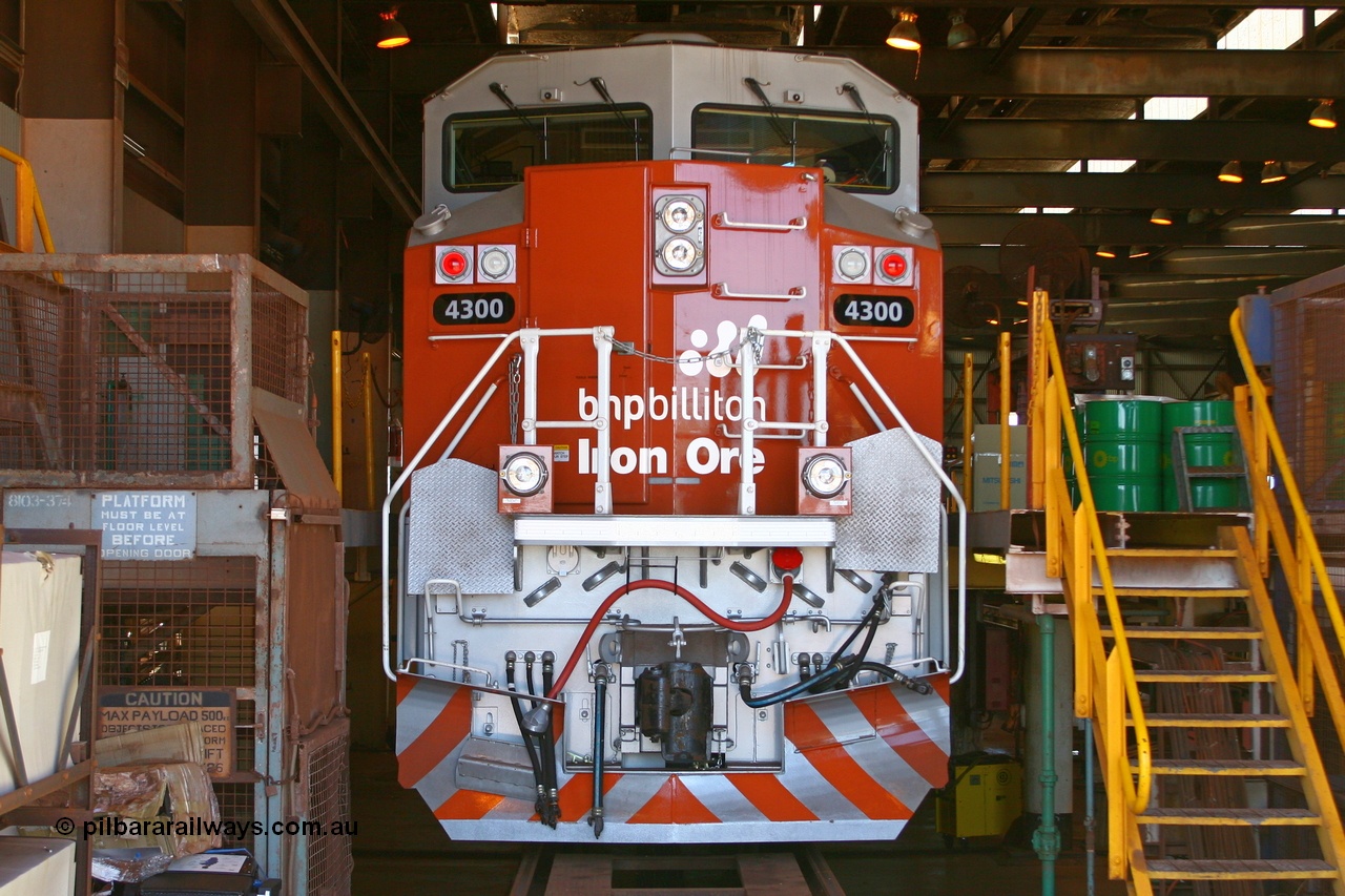 060416 3478r
Nelson Point Locomotive Service Shop, BHP Billiton's class leader of the Electro-Motive built SD70ACe/LC locomotive 4300 serial 20038540-001 which was actually purchased as a spare parts source, sits in the shed during commissioning, of note is that it has no windscreen protectors fitted. 16th April 2006. This unit was subsequently stripped and then the frame and cab eventually scrapped in January 2016 without ever hauling a train.
Keywords: 4300;Electro-Motive;EMD;SD70ACe/LC;20038540-001;