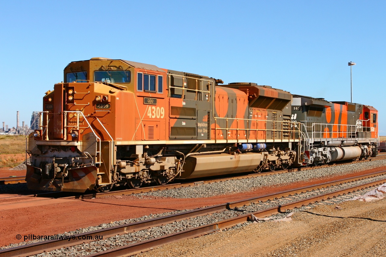 060710 6277r
Boodarie Yard, BHP Billiton Electro-Motive built SD70ACe/LC unit 4309 serial 20038540-010 and CM40-8M 5638 shunt through the yard during commissioning trials of Car Dumper 4 at Finucane Island. Boodarie Yard has just been expanded and the fence has since been put back up. 10th July 2006. Several years later both these locos and the HBI Plant in the background would all be gone!
Keywords: 4309;Electro-Motive;EMD;SD70ACe/LC;20038540-010;