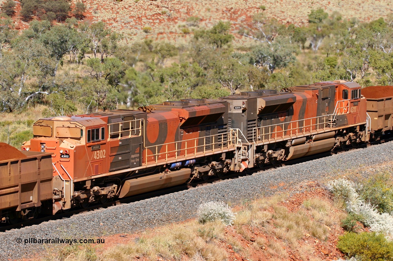 060714 6737r
Hesta, a brace of BHP Billiton Electro-Motive built SD70ACe/LC mid-train units 4302 'Mooka' serial 20038540-003 and 4311 'Poonda' serial 20038540-012 are in full power as they assist a loaded train climbing the grade at the 226 km. 14th July 2006.
Keywords: 4302;Electro-Motive;EMD;SD70ACe/LC;20038540-003;