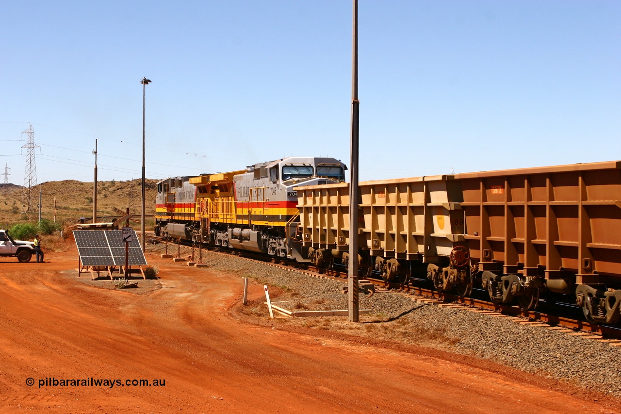 061209 8209r
Cape Lambert departure at the 6 km with Hamersley Iron General Electric Dash 9-44CW unit 7060 leading week old sister 7046 serial 57097 both resplendent in Pilbara Iron livery with an empty service bound for the West Angelas mine as the train examiner conducts the roll-by. 9th December 2006.
Keywords: 7046;GE;Dash-9-44CW;57097;