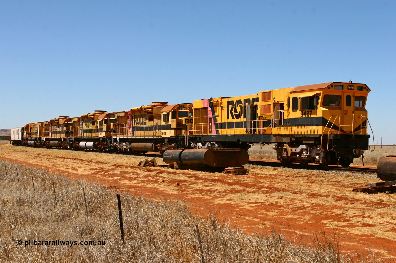 061209 8225r
Seven Mile on 38 Road, stored and stripped the Robe River ALCo units await their fate. Comeng WA ALCo rebuild C636R unit 9426 has already been sent to Perth and sister 9427 is stripped and ready to follow. The other units behind 9427 are ALCo M636 units 9416, 9413, 9415 and 9412. 9th December 2006.
Keywords: 9427;Comeng-WA;C636R;WA143-2;rebuild;ALCo;Schenectady-NY;C636;Conrail;6781;3499-2;