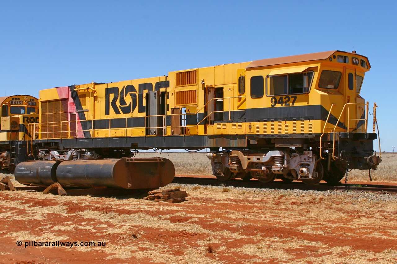 061209 8227r
Seven Mile 38 Road, retired Robe River Comeng WA ALCo rebuild model C636R unit 9427 serial WA143-2 sits stripped of engine, fuel tank and pilots ready for road haulage to Perth for rebuilding and use on FMG rail construction trains in May-June 2007. This unit was originally built by ALCo as C636 serial 3499-2 of January 1968 for Pennsylvania Railroad as #6331, and was purchased off Conrail as #6781 in 1986 and was rebuilt by Comeng WA prior to delivery in January 1987. 9th December 2006.
Keywords: 9427;Comeng-WA;C636R;WA143-2;rebuild;ALCo;Schenectady-NY;C636;Conrail;6781;3499-2;