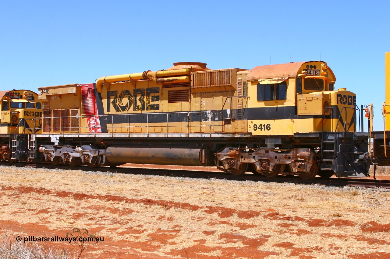 061209 8231r
Seven Mile 38 Road, former Robe River AE Goodwin built ALCo M636 unit 9416 serial G6046-16 awaits a new owner. 9416 was originally built for Hamersley Iron as #4045 and was purchased by Robe right before shipping to Hamersley Iron and entered service in February 1973. The ducting on the hood is the air to air intercooler modifications that Robe trialled. Also of note is the unit is fitted with an ALCo C630 fuel tank, swapped when the C630 units were rebuilt into the CM40-8M units. 9th of December 2006.
Keywords: 9416;AE-Goodwin;ALCo;M636;G6046-16;