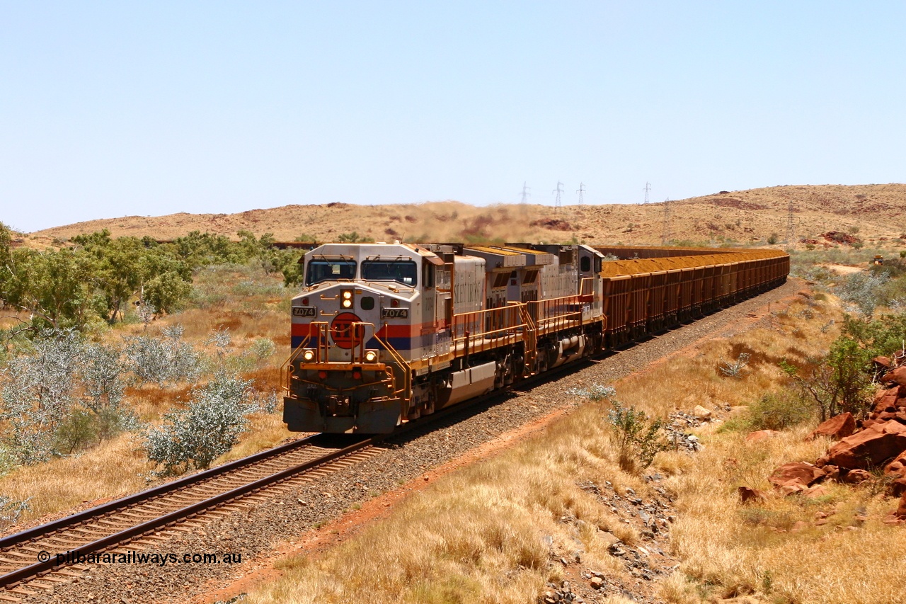 061209 8277r
North of Harding Siding near the 31 km, double Hamersley Iron General Electric built Dash 9-44CW units 7074 serial 47753 and 7084 serial 47763 are in once foreign territory on the Cape Lambert line with a loaded West Angelas 'Marra Mamba' train struggling with the grade, curve and maximum tonnage. 9th December 2006.
Keywords: 7074;GE;Dash-9-44CW;47753;