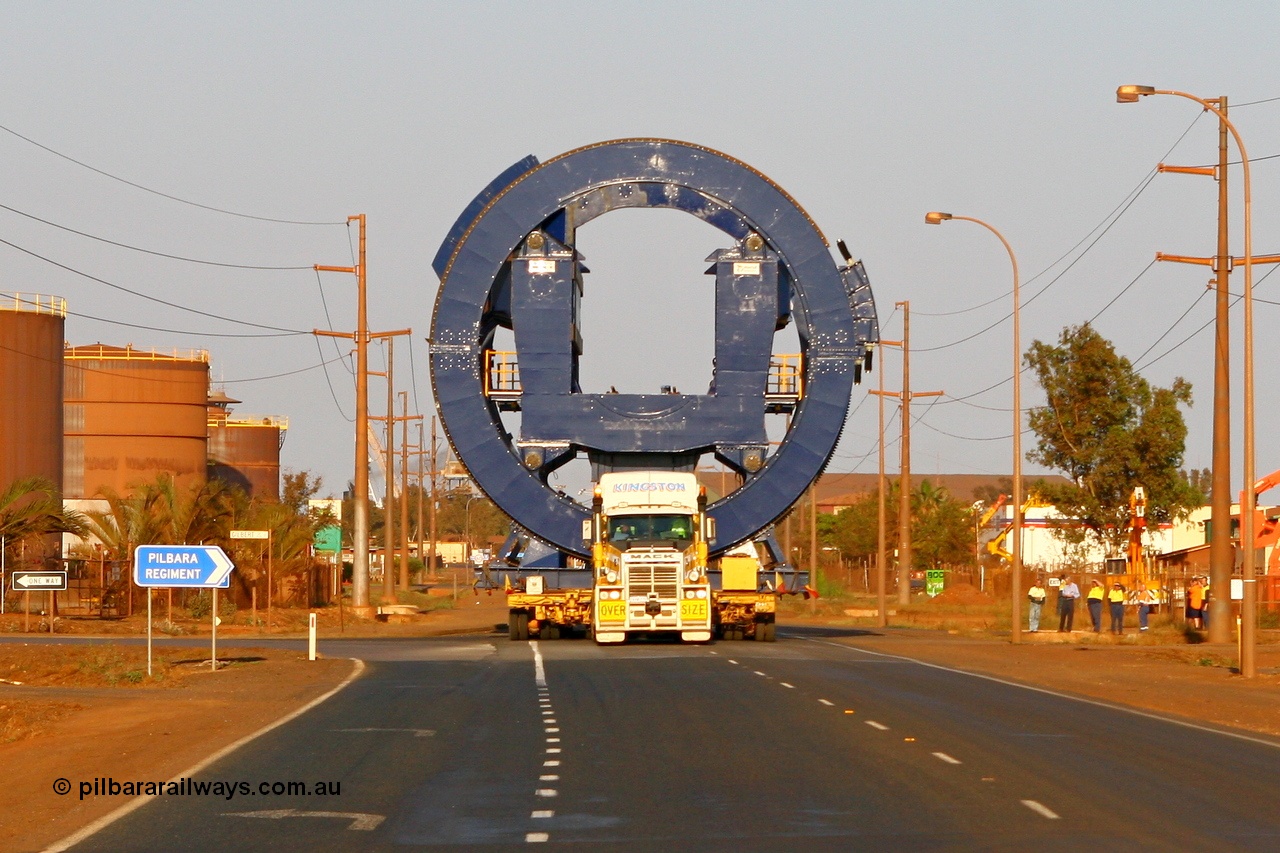 070922 1029r
Port Hedland, Wilson Street, Kingston Mack prime mover power the 256 wheel float with the first Metso rotary dumper cell built for FMG. Seen here powering up and away from the port. Of note is these cells for FMG will clamp the top of the ore waggon, similar to the Pilbara Iron dumpers, while the BHP cells clamp down on side pockets in the waggons. Sunday 23rd September 2007.
Keywords: Metso;