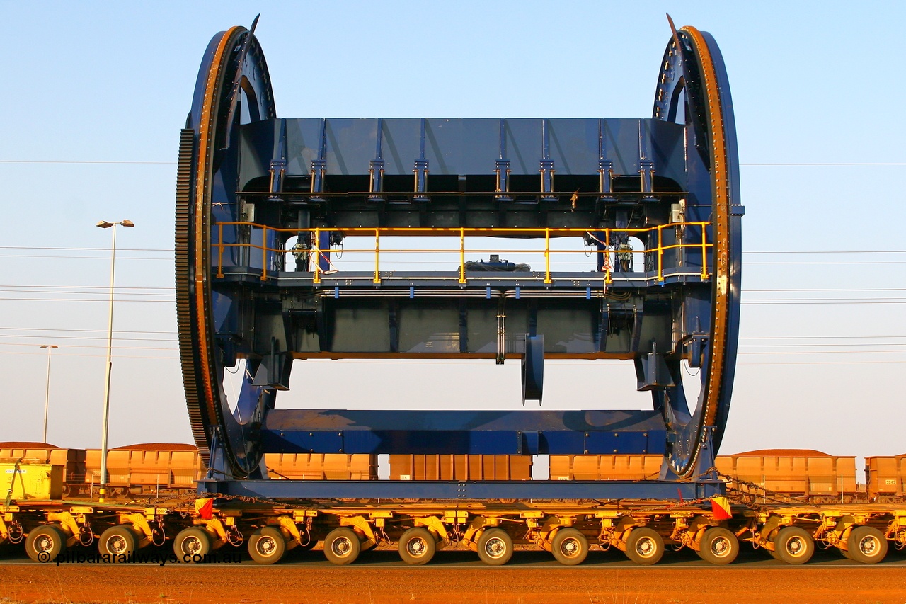 070923 1050r
Port Hedland, Wilson Street, side on view of FMG's Metso built rotary car dumper cell in-transit past loaded BHP ore waggons. Of note, these cells for FMG will clamp the top of the waggons similar to Pilbara Iron car dumpers while the BHP cells clamp down on side pockets in the waggons. Sunday 23rd September 2007.
