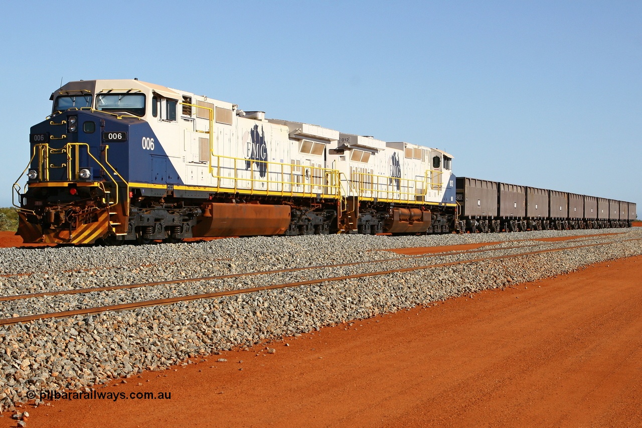 080120 1482r
Rowley Yard, FMG's General Electric built Dash 9-44CW DC locomotives 006 serial 58183 is coupled to 012 serial 58189 and five pairs of Chinese made ore waggons at the marshalling yard. These units were the last locomotives of this model built by General Electric. 20th January 2008.
Keywords: FMG-006;GE;Dash-9-44CW;58183;