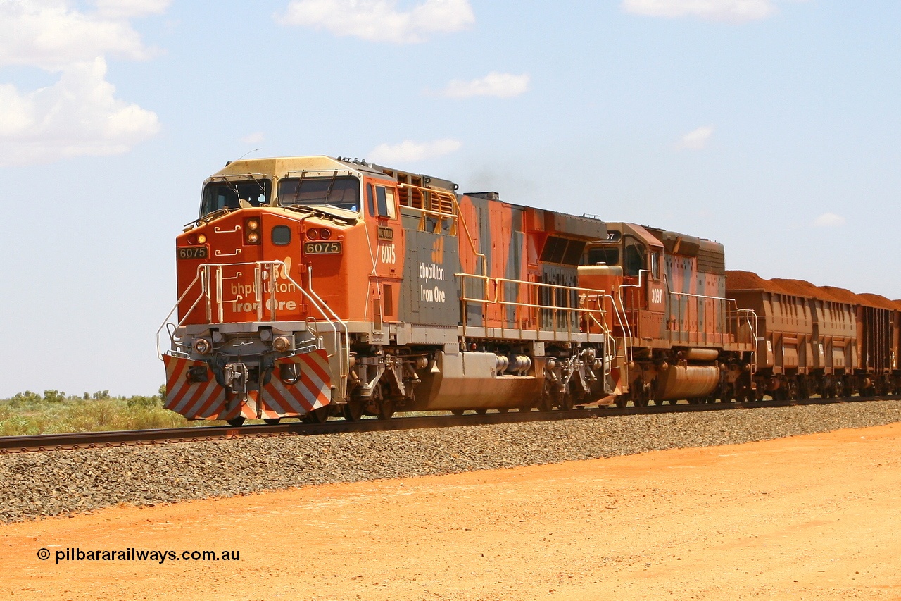 080124 1612r
Mooka, BHP Billiton GE AC6000 unit 6075 'Newman' serial 51067 which was repainted in the new 'earth' livery when its' 7HDL-16 was replaced with an GEVO-16 engine during overhaul. The livery varies from that applied to 6076, which was the first AC to so painted. Loaded train with SD40R, 26 km, 24th January 2008.
Keywords: 6075;GE;AC6000;51067;