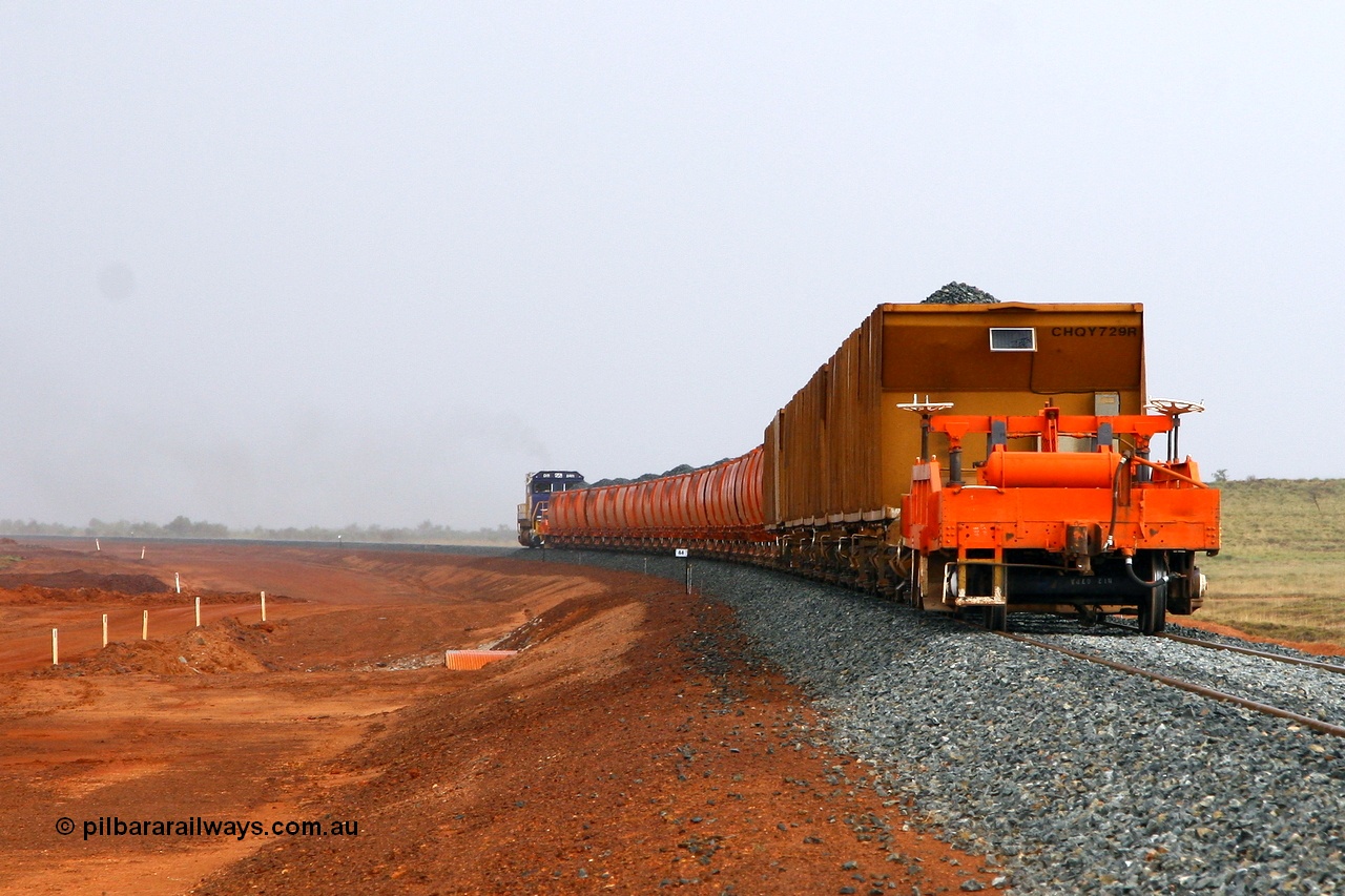 080202 1918r
Indee, at the 44 km post on the FMG railway a loaded ballast train heads south round the curve and into a summer rain squall. 2nd February 2008.
