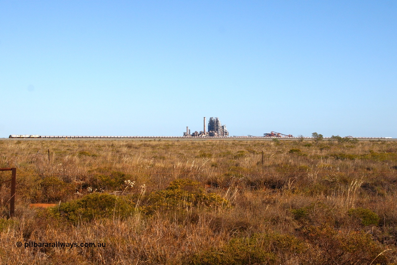 080524 2247r
Boodarie, panoramic view of FMG's General Electric built Dash 9-44CW unit 004 serial 58181 leading two sister units, 130 ore waggons and a two waggon compressor set as they pass in front of the failed BHP Billiton HBI plant. 24th May 2008.
Keywords: FMG-004;GE;Dash-9-44CW;58181;