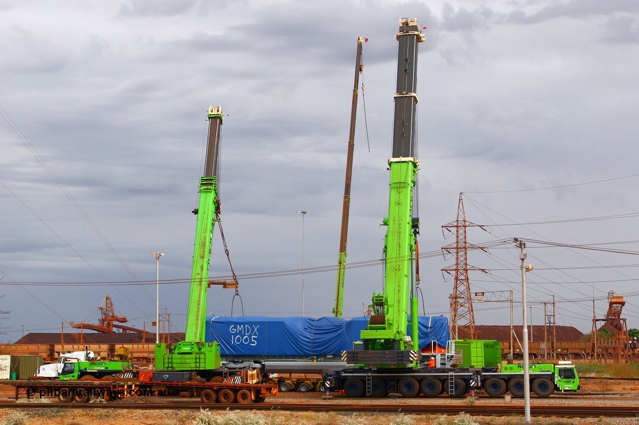 080612 2546
Nelson Point, the first BHP Billiton Electro-Motive built SD70ACe 'Pumpkin' unloaded off the heavy lift ship DA QIANG on Thursday 12th June 2008. The crane behind the loco is for removing the tarp the other two are a 300 tonne on the left an a massive 500 tonne on the right.
Keywords: GMDX1005;Electro-Motive;EMD;SD70ACe;