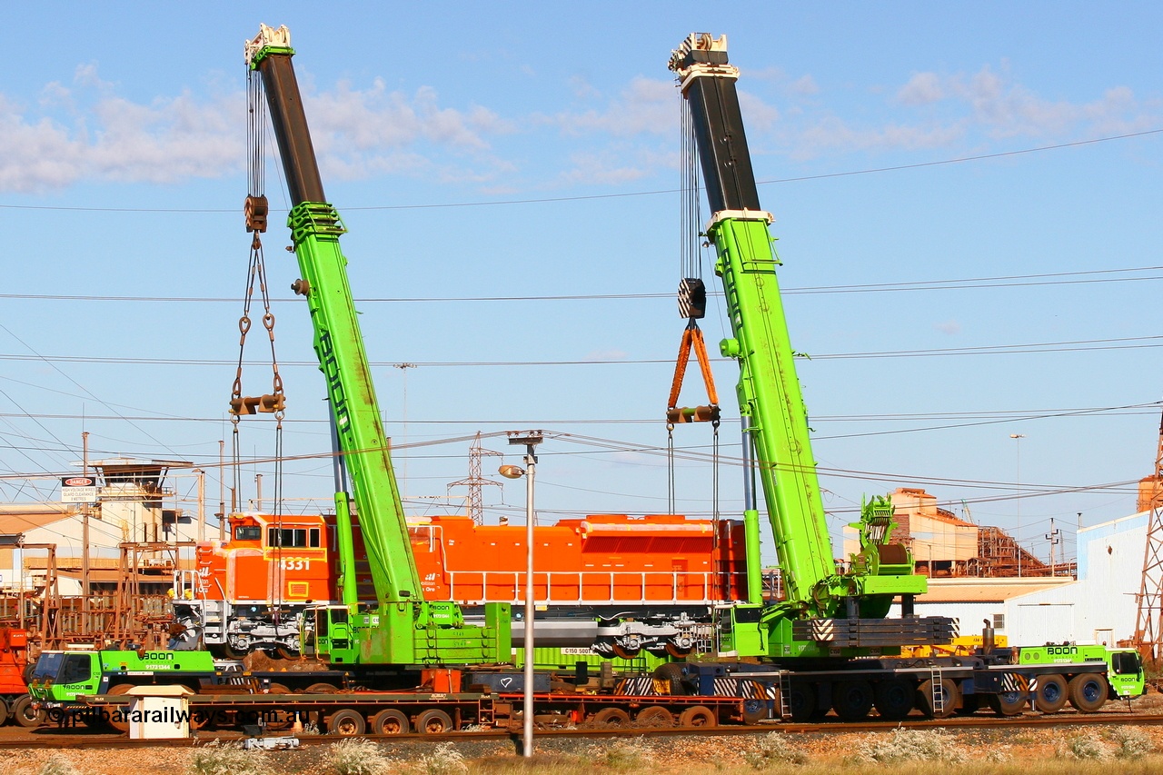 080614 2605
Nelson Point hard stand sees BHP Billiton's latest Electro-Motive SD70ACe unit 4331 serial 20066862-060 originally built for BNSF as BNSF 9189 in all over BNSF orange referred to as 'pumpkins'. A 300 tonne crane on the left and an even bigger 500 tonne crane combine to lift the 200 tonne mass of the 4300 hp SD70ACe locomotive, 14th June 2008.
Keywords: 4331;Electro-Motive;EMD;SD70ACe;20066862-060;BNSF-9189;