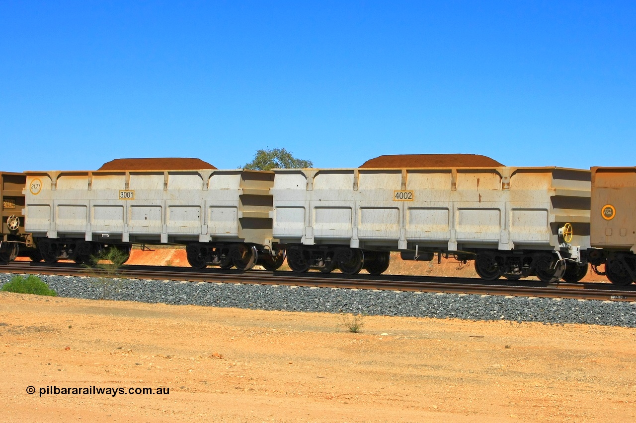 090814 2097r
Hunter Siding, FMG trial waggons built by CNR QRRS in China and one tonne lighter than the existing fleet. 3001 is the slave waggon with the rotary coupling and stencilled as 21.7 tonnes, 4002 is the control waggon and should be 21.9 tonnes. FMG now has a large fleet of these waggons built by CNR QRRS or Qiqihar Railway Rolling Stock Co. Ltd of China Northern, with the tare weights now at 22.6 tonnes. 14th August 2009.
Keywords: 3001-4002;CNR-QRRS-China;FMG-ore-waggon;