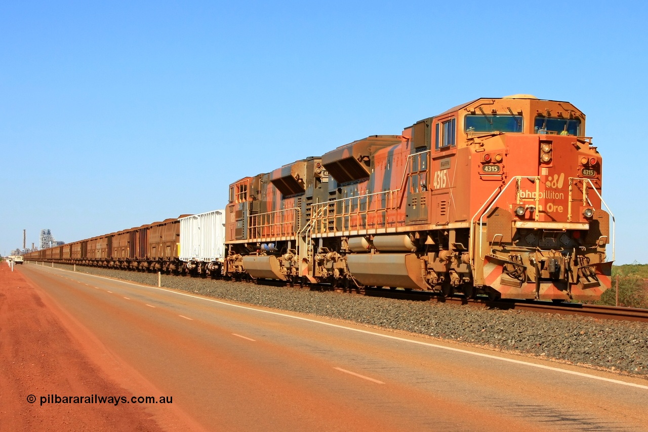 110414 0104r
Finucane Island, bit of history in this image, the second unit has been returned to the USA, the white index waggons are no longer used, the road way has been moved well left of this and a second track no occupies this road and the HBI plant in the background has been demolished. BHP Billiton's 4315 'Mijarrpa' serial 20058712-002 from the second order of EMD SD70ACe/LC locomotives built by Electro-Motive in London Ontario in October 2006 leads a loaded train towards the car dumpers at Finucane Island on what used to be the Goldsworthy Mining Ltd mainline. 14th April 2011.
Keywords: 4315;Electro-Motive-London-Ontario;EMD;SD70ACe/LC;20058712-002;