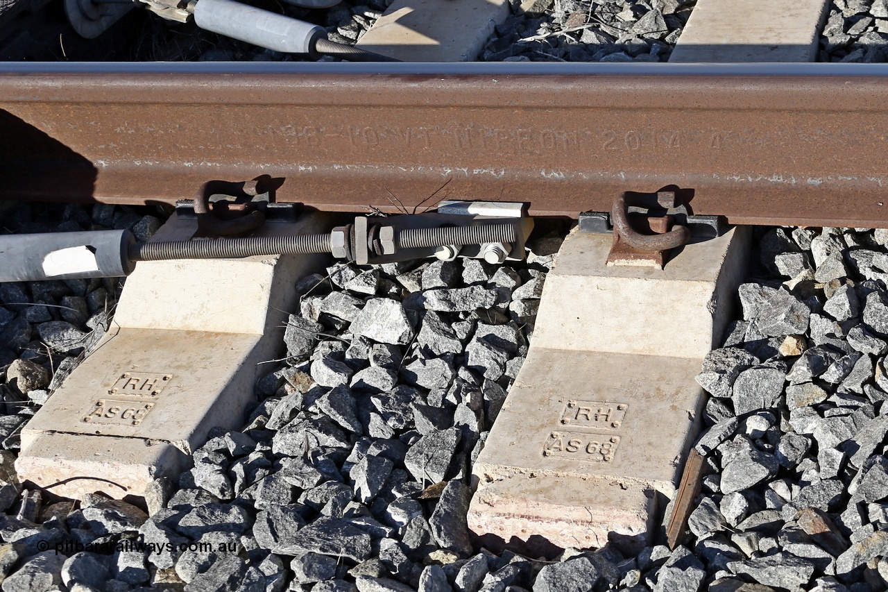 180701 9485r
Roy Hill track formation near the 63 km. Sleepers are moulded RH for Roy Hill and AS68 as manufactured to suit AS68 rail profile. The rail is moulded 136 10 VT NIPPON 2014 4 which translates to 136 Ib/yard (or 68 kg/m), 10 for Low Alloy, VT for processes of hydrogen elimination as Vacuum Treated, NIPPON is the manufacturer Nippon Steel, Japan, 2014 year rolled and 4 is month rolled.
