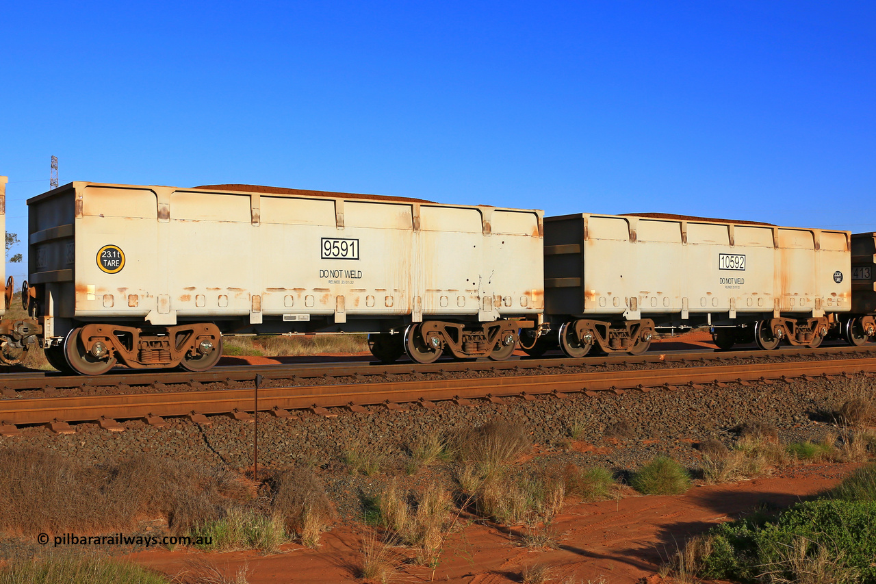 9591-10592 230902 7241
FMG 9591 and 10592 on a loaded train at Boodarie, September 2, 2023. Sixty eight waggons numbered from 9591 slave and 10592 control, up to 9657 slave and 10658 control built by CRRC Qiqihar in January and February 2022, and 9625 and higher in June 2022 with lined body stencilled DO NOT WELD and the relined date.
