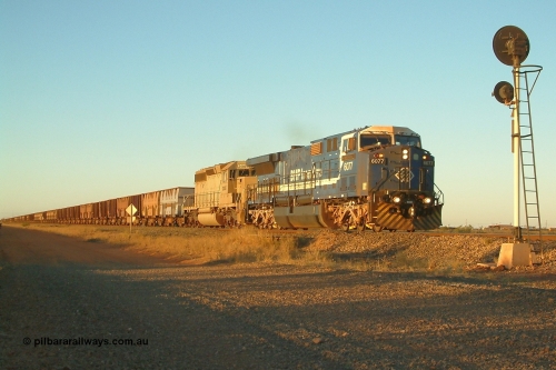 040811 173538r
Goldsworthy Junction BHP GE AC6000 6077 'Nimingarra' serial 51069 and EMD SD40-2 3085 serial 786170-25 formally Union Pacific UP 3523 are in charge of an empty train at signal TR13 (transfer road switch, Goldsworthy Junction) mid-train units can just be seen in frame 11th August 2004.
Keywords: 6077;GE;AC6000;51069;