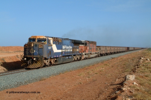 050204 080056r
Mooka, BHP GE AC6000 final unit 6077 serial 51069 with EMD SD40R 3091 serial 31496 originally Southern Pacific SD40 SP 8415 power along at the 30 km mark with an empty 200 waggon train, smoke can just been seen coming from mid train units 6071 and 3083 4th February 2005.
Keywords: 6077;GE;AC6000CW;51069;