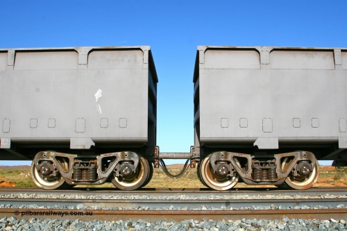 080116 1373r
Chapman Siding, view showing the bogies and bar coupling, train pipe, control pipe and electrical jumper of FMG married pair of 'slave' 1395 on the left and 'control' 2396 on the right. The BHP Newman line in the back ground. 16th January 2008.
Keywords: CSR-Zhuzhou-Rolling-Stock-Works-China;