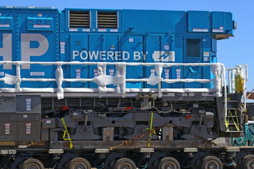 w r251114 4371
BHP's Battery Electric Locomotive 9001 class leader, a brand new Wabtec built FLXdrive ™ battery electric locomotive, or BEL, sits in the Gobi hard stand area of Pilbara Ports Authority as it awaits delivery to site.
The BEL's, 9001 and 9002 were built by Wabtec at their Erie, Pennsylvania, USA plant and are designated as model FXH70C. Both locos were shipped on the BBC St Petersburg and road transport is provided by Tutt Bryant.
9001 has serial number 66453 and a built date of Dec 2023.
November 14, 2025.
Keywords: 9001;66453;Wabtec;BEL;FXH70C;