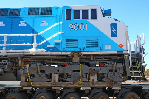 w r251114 4392
BHP's Battery Electric Locomotive 9001 class leader, a brand new Wabtec built FLXdrive ™ battery electric locomotive, or BEL, sits in the Gobi hard stand area of Pilbara Ports Authority as it awaits delivery to site.
The BEL's, 9001 and 9002 were built by Wabtec at their Erie, Pennsylvania, USA plant and are designated as model FXH70C. Both locos were shipped on the BBC St Petersburg and road transport is provided by Tutt Bryant.
9001 has serial number 66453 and a built date of Dec 2023.
November 14, 2025.
Keywords: 9001;66453;Wabtec;BEL;FXH70C;